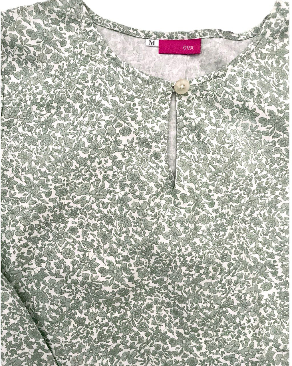 Close-up of Floral long blouse with a brand label on a white background