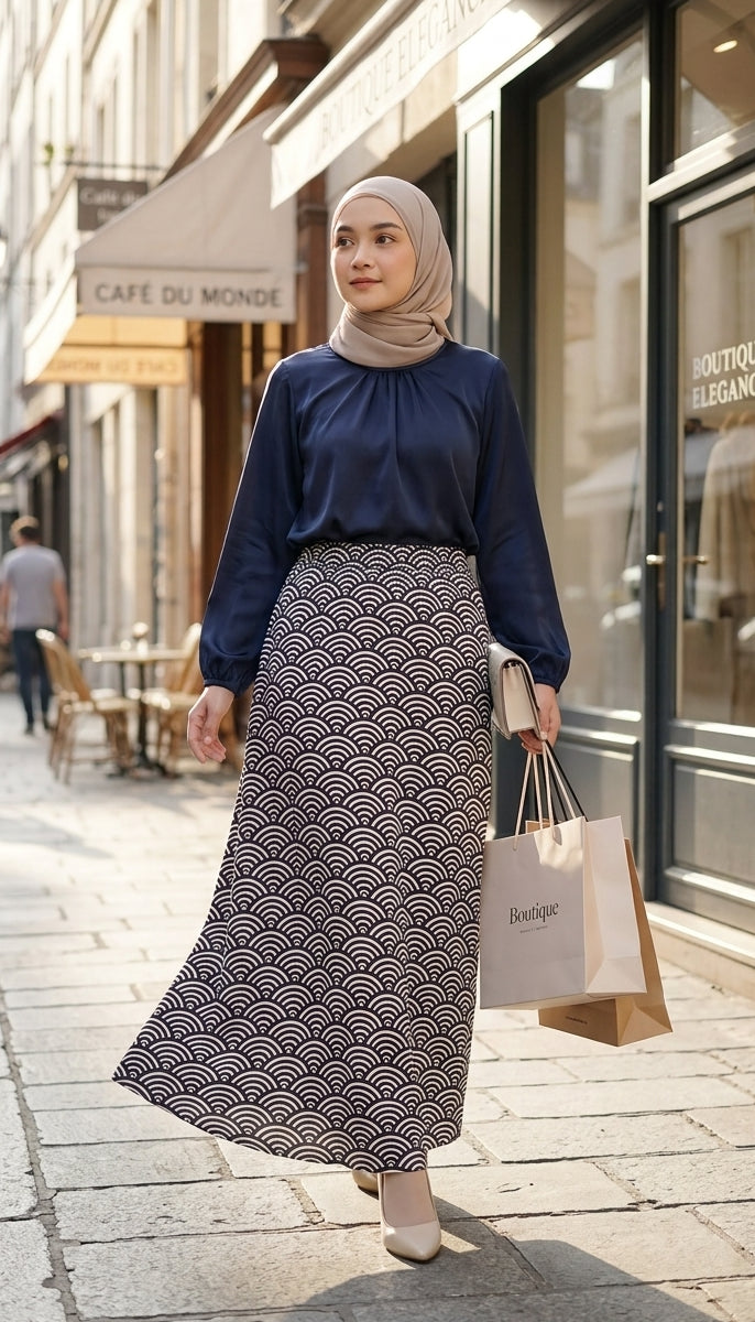 model with dark blue blouse and patterned aline skirt walking in the streets