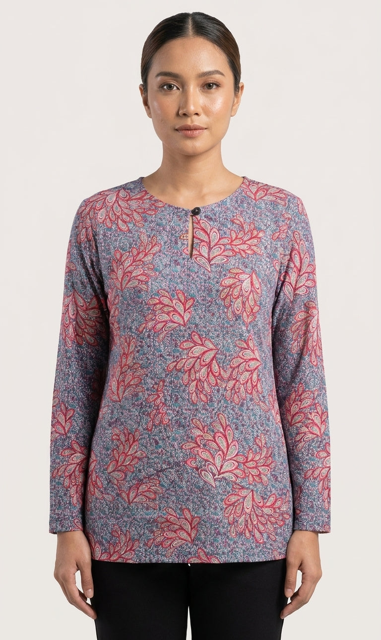 model wearing a floral blouse in reddish feather like floral and blue 