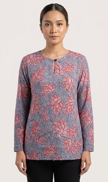 model wearing a floral blouse in reddish feather like floral and blue 