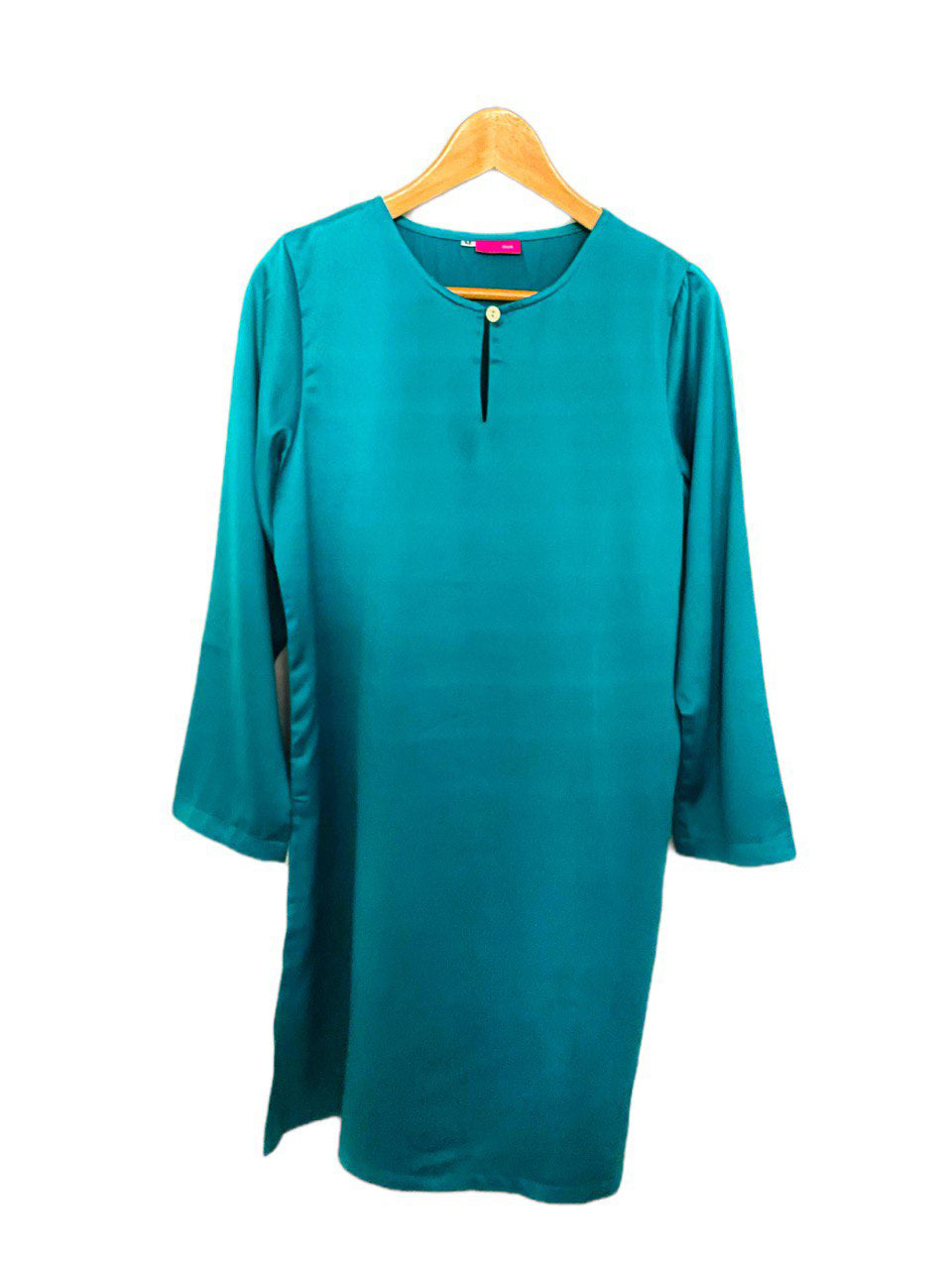 Teal long blouse on a wooden hanger against a white background