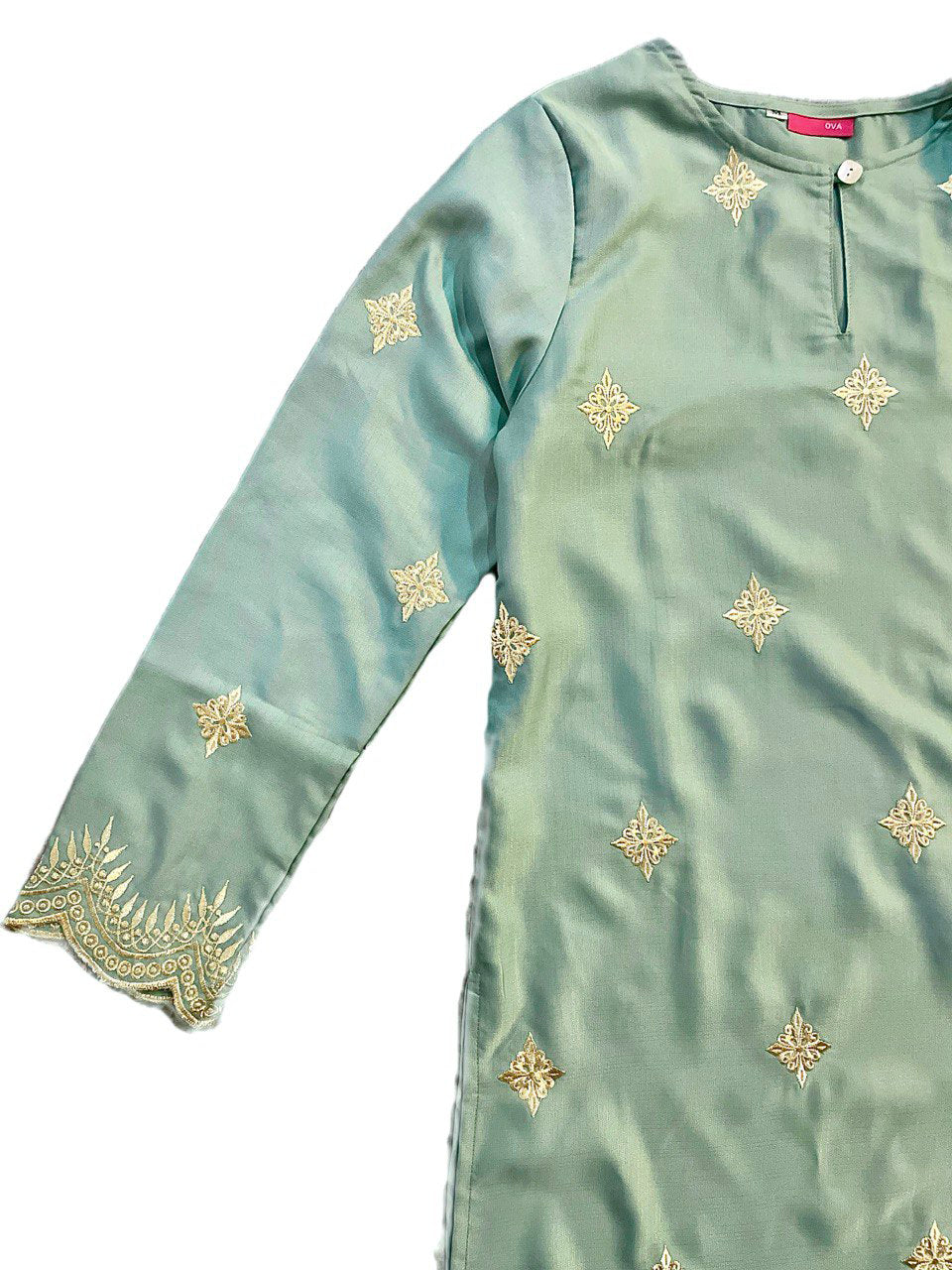 Close-up Light blue long blouse with gold embroidery on a white background