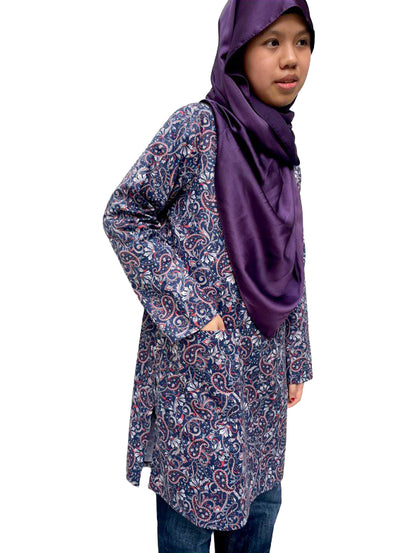 Person wearing a floral long blouse and purple hijab on a white background