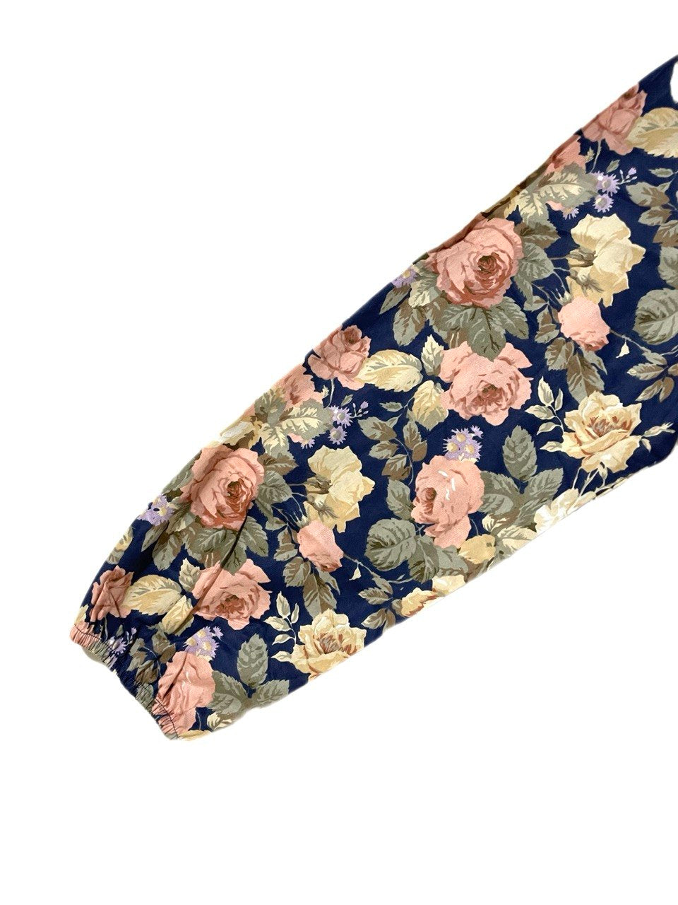 Close up of a sleeve with pink and yellow flowers on a navy blue background