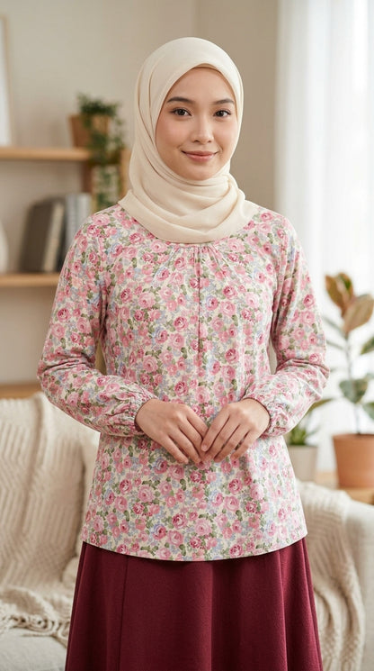 Woman wearing a floral blouse and hijab in a home setting