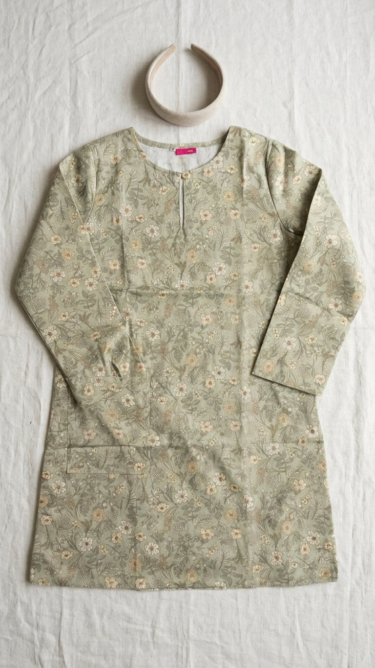 a cotton floral blouse flat on a plain cream background 