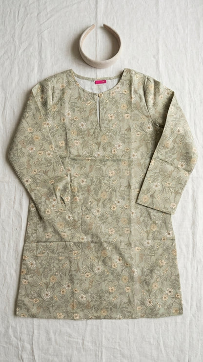 a cotton floral blouse flat on a plain cream background 