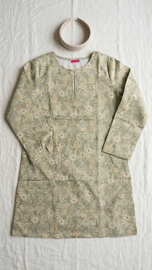 a cotton floral blouse flat on a plain cream background 