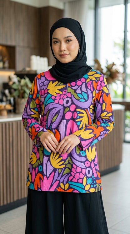 Woman wearing a colorful floral-patterned top in an indoor setting