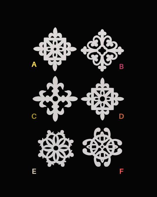 Six ornamental scroll and floral cutout designs labeled A through F on a black background, arranged in two columns of three.
