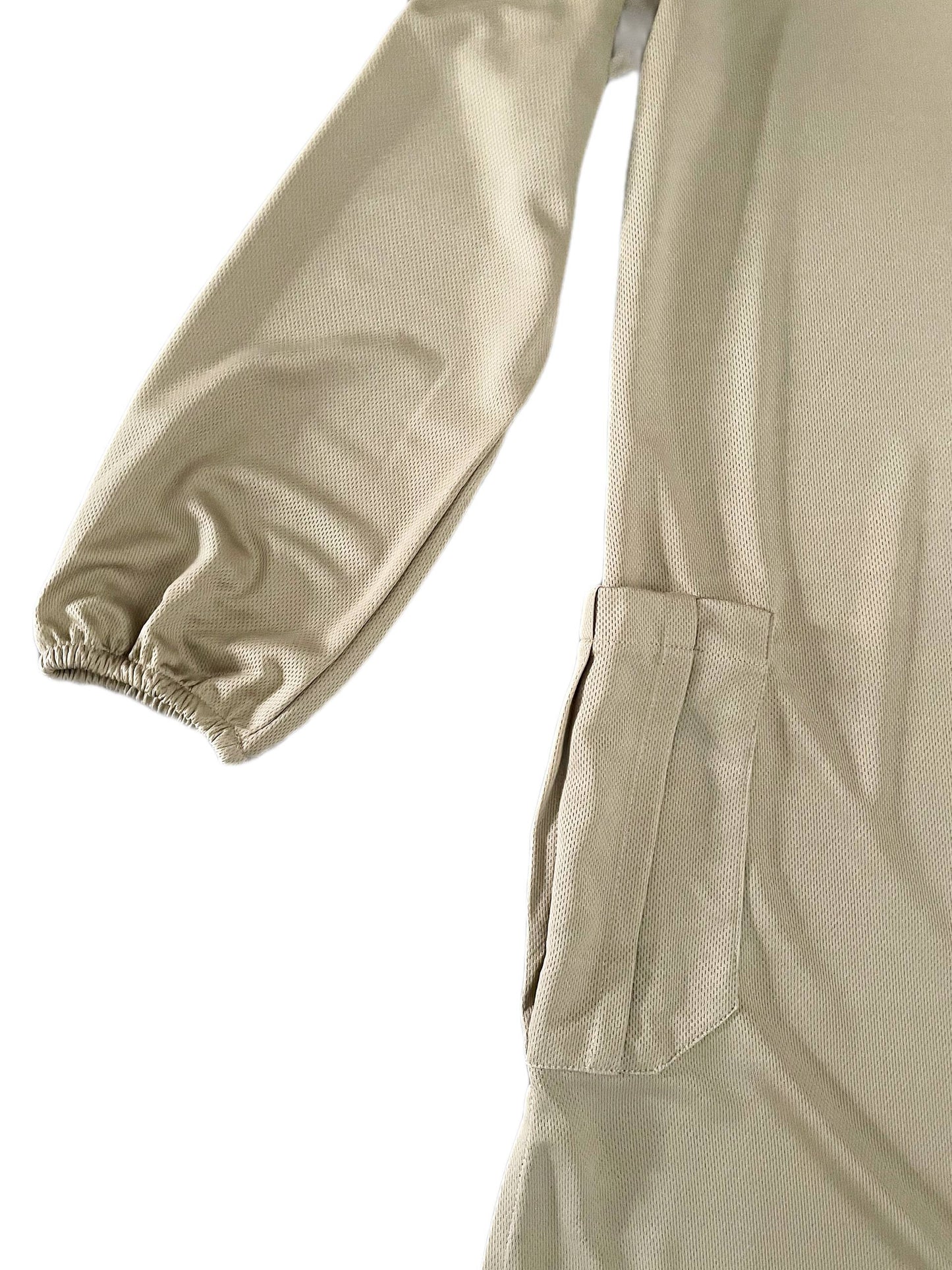 Close-up of beige dry fit tshirt with a pocket and sleeve on a white background