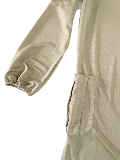 Close-up of beige dry fit tshirt with a pocket and sleeve on a white background
