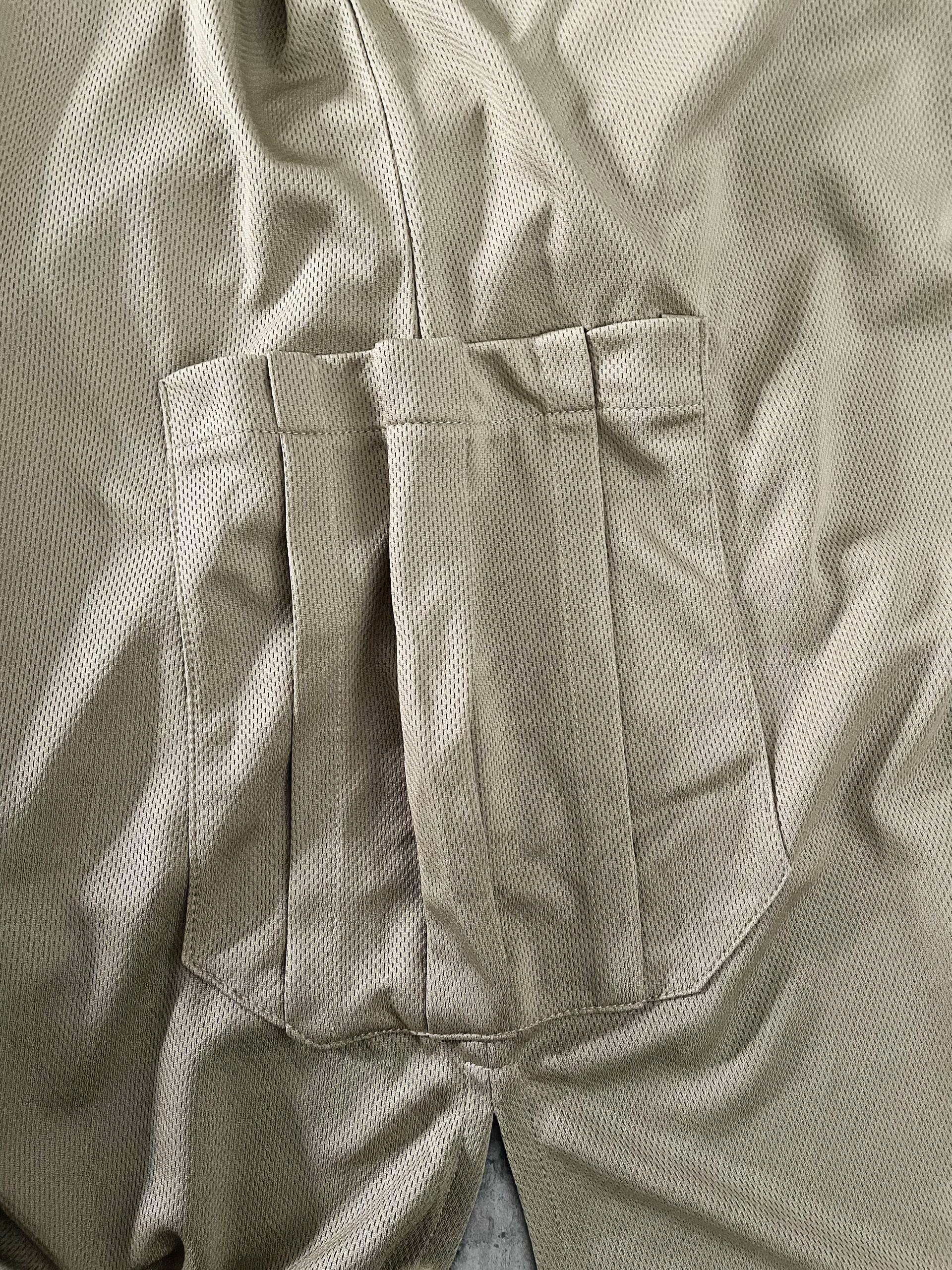 Close-up of beige dry fit tshirt with two side pockets 