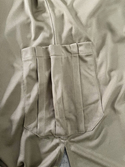 Close-up of beige dry fit tshirt with two side pockets 
