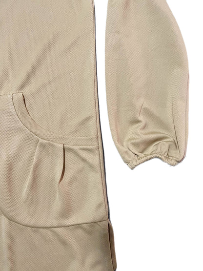 close-up of Beige dry fit tshirt with elastic cuffs sleeves and pockets on a white background