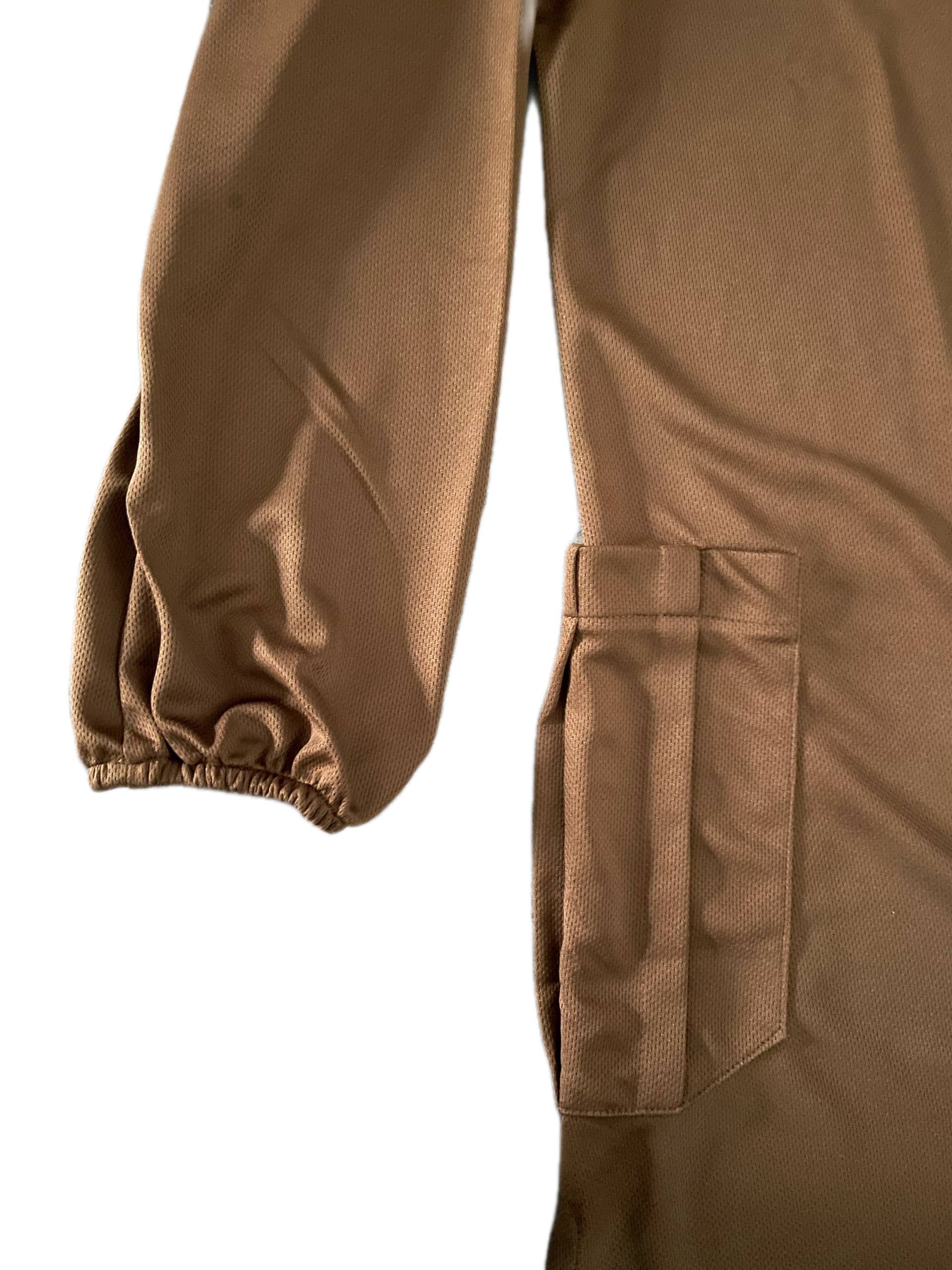 close-up of elastic sleeves of Brown long dry fit shirt with a pocket on a white background
