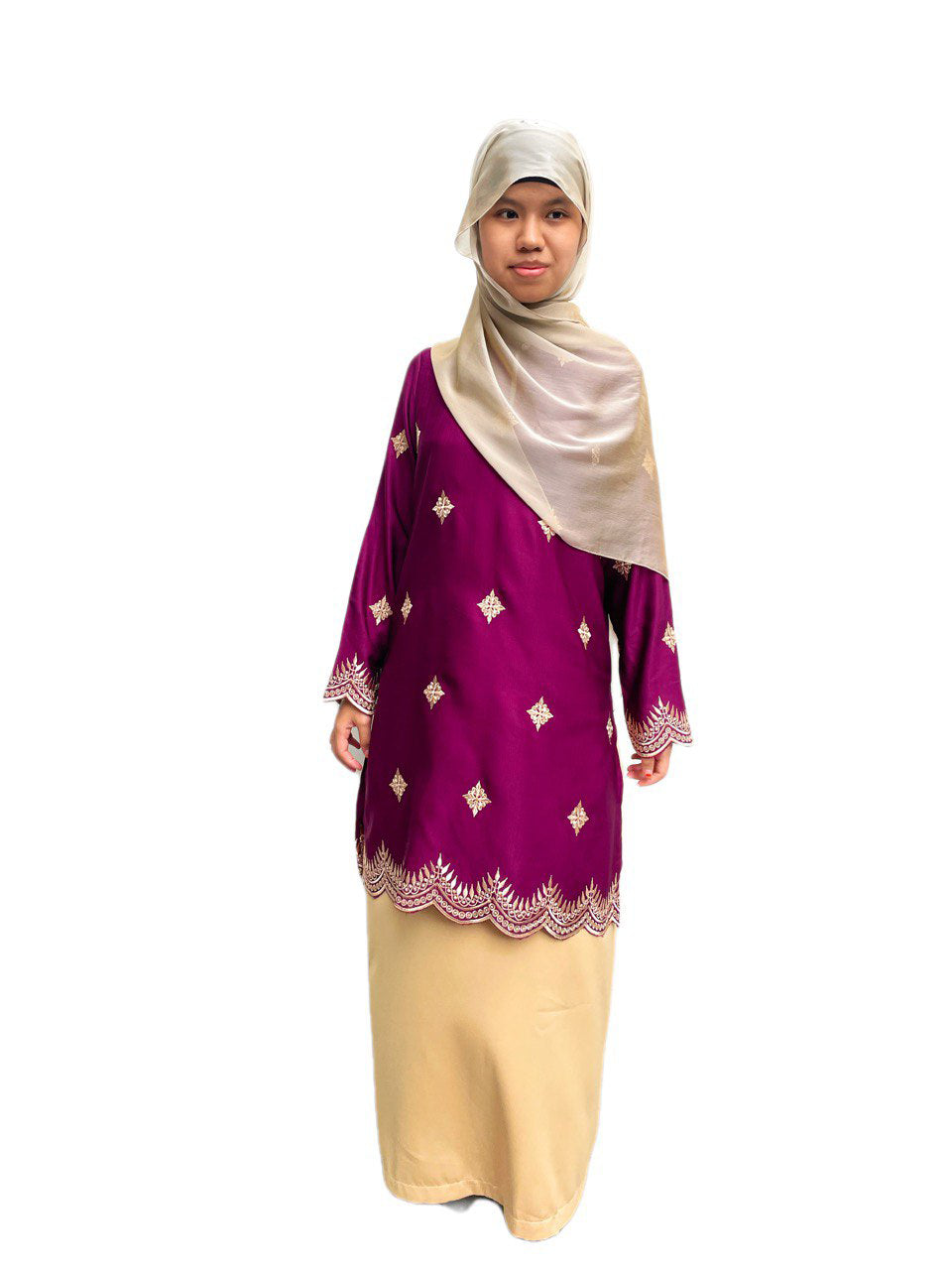Woman wearing a purple long blouse with gold patterns and a light yellow skirt and a beige hijab on a white background