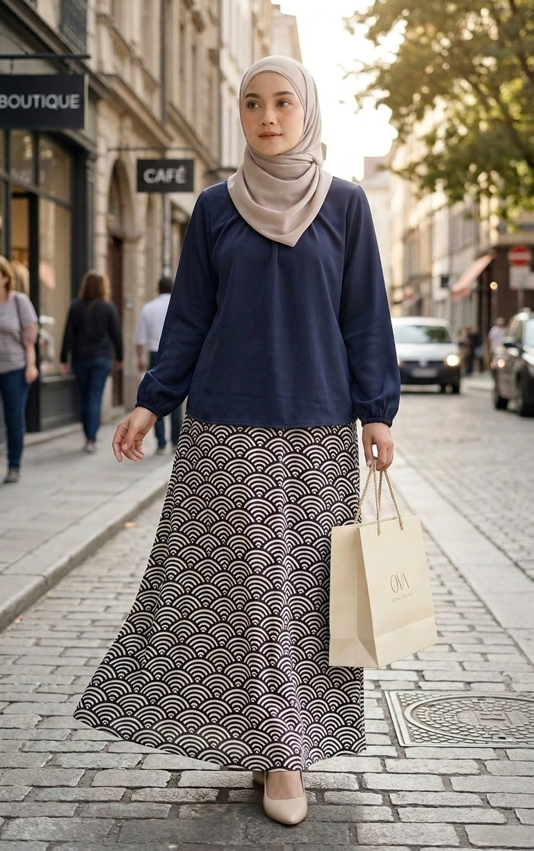 model with dark blue blouse and patterned aline skirt walking in the streets