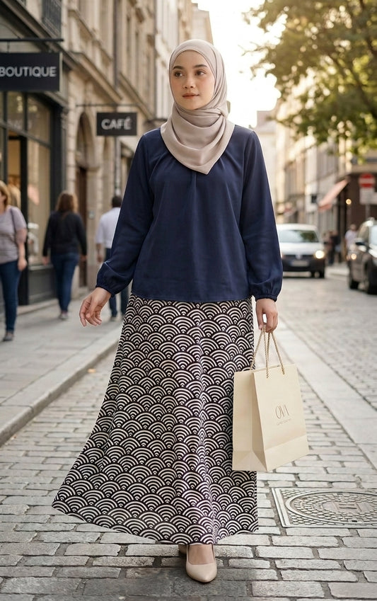 model with dark blue blouse and patterned aline skirt walking in the streets