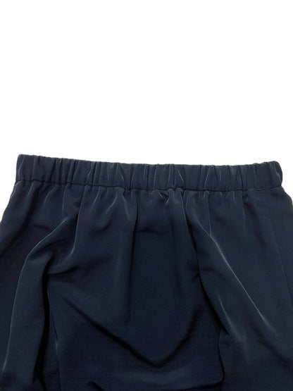 Close-up of dark navy blue fabric with an elastic waistband, shown against a plain white background.