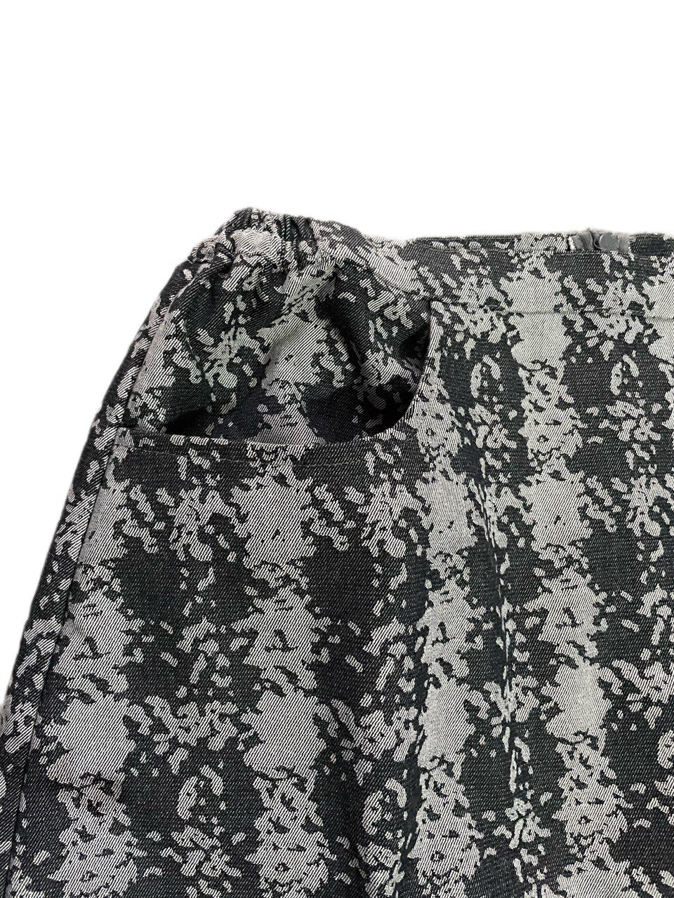 Close-up of a checkered fabric with black and gray design on a white background