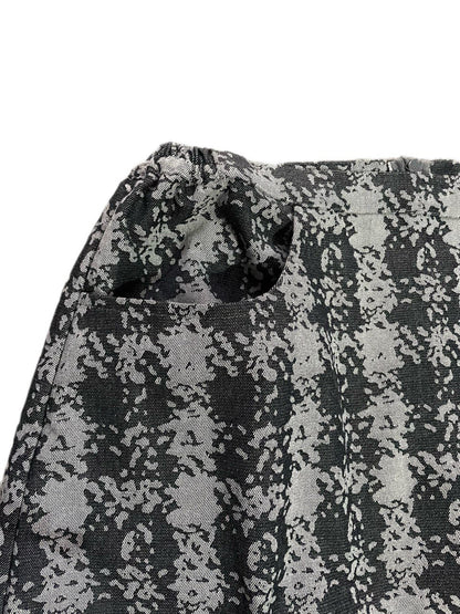 Close-up of a checkered fabric with black and gray design on a white background