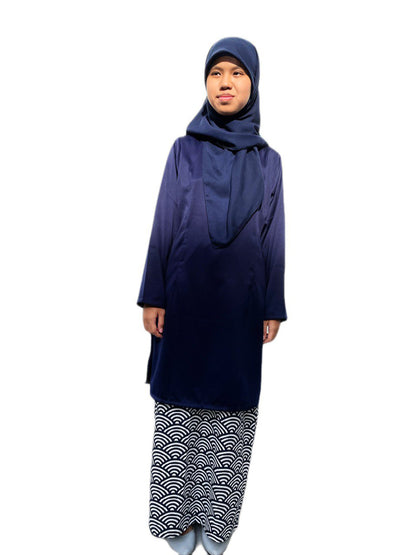 Person wearing a navy blue outfit with a patterned skirt on a white background