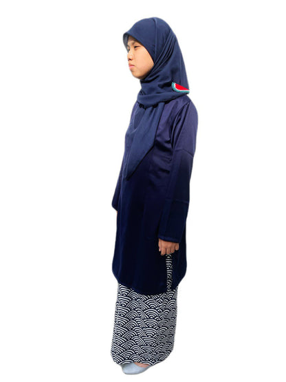 Person wearing a navy blue outfit with a patterned skirt on a white background
